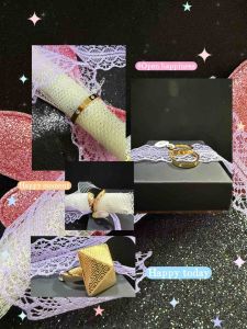 Gold rings on lace-wrapped bottle with pink glittery wings.
