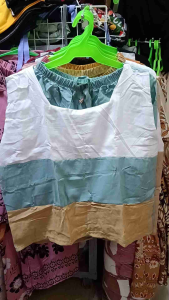 SABRINA COMBI TERNO SHORT PLAIN FREESIZE FOR WOMEN - White and green color block tank top - Green shorts - Casual summer wear - Indoor setting with decorative plants.