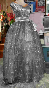 Ladies ball gown in sleeveless style with bow belt grey color shimmering look. Best fit for ladies standing 5 ft to 5.3 ft tall .