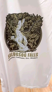 ReignDri-Fit White Dri-Fit T-shirt with Salugsog Falls graphic and tagline "Peaceful Christ in the Wilderness" on natural background. Small to Medium Size Available.