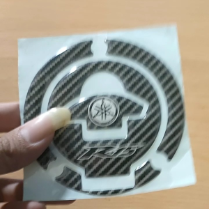 Emblem Sticker Timbul Tutup Bensin Yamaha R15 & Vixion\\n\\n Apa Itu Stiker Timbul Untuk Motor?\\n\\nStiker timbul untuk motor adalah aksesori yang dirancang khusus untuk memberikan tampilan unik dan menarik pada kendaraan Anda. Desain emblem motor ini dapat dipasang di berbagai bagian motor, seperti tutup bensin Yamaha R15 dan Vixion. Stiker timbul memiliki tekstur yang berbeda dengan stiker biasa, memberikan efek tiga dimensi yang menarik. Dengan memilih stiker timbul, Anda dapat menambahkan sentuhan personal pada motor Anda dan membuatnya lebih berbeda dari motor lainnya.\\n\\n Desain Emblem Motor: Tips dan Trik\\n\\nUntuk mendapatkan desain emblem motor yang sempurna, ada beberapa hal yang perlu dipertimbangkan. Pertama, pastikan desain emblem sesuai dengan gaya motor Anda. Misalnya, jika Anda memiliki Yamaha R15 atau Vixion, pilihlah desain yang cocok dengan karakteristik motor tersebut. Kedua, pertimbangkan warna dan kontras stiker timbul dengan bodi motor Anda. Pilihlah kombinasi warna yang seimbang dan menarik untuk menciptakan efek visual yang kuat. Ketiga, pastikan stiker timbul yang Anda pilih memiliki kualitas tinggi dan tahan lama, sehingga dapat bertahan dalam kondisi cuaca ekstrem dan penggunaan sehari-hari.\\n\\n Cara Memilih Stiker Timbul Sesuai Dengan Motor Anda\\n\\nMemilih stiker timbul yang tepat untuk motor Anda memerlukan beberapa pertimbangan. Pertama, ukuran stiker harus sesuai dengan bagian motor yang akan ditempelkan. Misalnya, jika Anda ingin menempelkan stiker timbul pada tutup bensin Yamaha R15 atau Vixion, pastikan ukuran stiker tersebut sesuai dengan ukuran tutup bensin motor Anda. Kedua, pertimbangkan material stiker timbul. Pilihlah stiker yang terbuat dari bahan berkualitas tinggi dan tahan lama, sehingga dapat bertahan dalam kondisi cuaca ekstrem dan penggunaan sehari-hari. Ketiga, pastikan stiker timbul yang Anda pilih memiliki desain yang sesuai dengan gaya motor Anda.\\n\\n Mengapa Anda Harus Memilih Stiker Timbul Untuk Motor Anda?\\n\\nAda beberapa alasan mengapa Anda harus memilih stiker timbul untuk motor Anda. Pertama, stiker timbul dapat memberikan tampilan unik dan menarik pada motor Anda, membuatnya berbeda dari motor lainnya. Kedua, stiker timbul memiliki kualitas yang lebih baik dibandingkan dengan stiker biasa, sehingga dapat bertahan dalam kondisi cuaca ekstrem dan penggunaan sehari-hari. Ketiga, stiker timbul dapat meningkatkan nilai jual motor Anda jika Anda berencana menjualnya di masa depan.\\n\\n Keunggulan dari Stiker Timbul Yamaha R15 & Vixion\\n\\nStiker timbul untuk Yamaha R15 dan Vixion memiliki beberapa keunggulan dibandingkan dengan stiker biasa. Pertama, stiker timbul memiliki tekstur yang berbeda dengan stiker biasa, memberikan efek tiga dimensi yang menarik. Kedua, stiker timbul terbuat dari bahan berkualitas tinggi dan tahan lama, sehingga dapat bertahan dalam kondisi cuaca ekstrem dan penggunaan sehari-hari. Ketiga, stiker timbul dapat dipasang pada berbagai bagian motor, seperti tutup bensin, membuat motor Anda tampak lebih unik dan menarik.\\n\\n Manfaat Menambahkan Stiker Timbul Pada Motor Anda\\n\\nMenambahkan stiker timbul pada motor Anda memiliki beberapa manfaat. Pertama, stiker timbul dapat memberikan tampilan unik dan menarik pada motor Anda, membuatnya berbeda dari motor lainnya. Kedua, stiker timbul dapat meningkatkan nilai jual motor Anda jika Anda berencana menjualnya di masa depan. Ketiga, stiker timbul dapat menjadi cara yang menyenangkan untuk mengekspresikan diri Anda melalui kendaraan Anda.\\n\\n Bagaimana Membeli dan Memasang Stiker Timbul Untuk Motor Anda?\\n\\nUntuk membeli dan memasang stiker timbul untuk motor Anda, ada beberapa langkah yang perlu dilakukan. Pertama, pilihlah stiker timbul yang sesuai dengan gaya motor Anda dan ukuran bagian motor yang akan ditempelkan. Kedua, pastikan stiker timbul yang Anda pilih memiliki kualitas tinggi dan tahan lama. Ketiga, ikuti langkah-langkah pemasangan stiker timbul yang disertakan dalam paket pembelian Anda.\\n\\n Langkah-langkah Membeli Stiker Timbul Terbaik\\n\\nBerikut adalah beberapa langkah yang dapat Anda ikuti untuk membeli stiker timbul terbaik untuk motor Anda:\\n\\n1. Pilihlah stiker timbul yang sesuai dengan gaya motor Anda dan ukuran bagian motor yang akan ditempelkan.\\n2. Pastikan stiker timbul yang Anda pilih memiliki kualitas tinggi dan tahan lama.\\n3. Bandingkan harga dan kualitas stiker timbul dari berbagai penjual untuk mendapatkan penawaran terbaik.\\n\\n Cara Memasang Stiker Timbul pada Motor Anda dengan Mudah\\n\\nBerikut adalah beberapa langkah yang dapat Anda ikuti untuk memasang stiker timbul pada motor Anda dengan mudah:\\n\\n1. Bersihkan bagian motor yang akan ditempelkan stiker timbul menggunakan pembersih kaca atau cairan pembersih khusus.\\n2. Potong stiker timbul sesuai dengan ukuran bagian motor yang akan ditempelkan.\\n3. Tempelkan stiker timbul pada bagian motor yang telah dibersihkan.\\n4. Tekan stiker timbul dengan kuat untuk memastikan stiker terpasang dengan baik.\\n\\n Perawatan dan Pemeliharaan Stiker Timbul Untuk Motor Anda\\n\\nUntuk mempertahankan kualitas stiker timbul pada motor Anda, ada beberapa tips yang dapat Anda ikuti. Pertama, bersihkan stiker timbul secara rutin menggunakan air sabun atau cairan pembersih khusus. Kedua, hindari menggosok stiker timbul dengan keras, karena dapat merusak permukaan stiker. Ketiga, jika stiker timbul mulai mengelupas atau rusak, gantilah stiker tersebut segera untuk mempertahankan penampilan motor Anda.\\n\\n Tips Mempertahankan Kualitas Stiker Timbul\\n\\nBerikut adalah beberapa tips yang dapat Anda ikuti untuk mempertahankan kualitas stiker timbul pada motor Anda:\\n\\n1. Bersihkan stiker timbul secara rutin menggunakan air sabun atau cairan pembersih khusus.\\n2. Hindari menggosok stiker timbul dengan keras, karena dapat merusak permukaan stiker.\\n3. Jika stiker timbul mulai mengelupas atau rusak, gantilah stiker tersebut segera untuk mempertahankan penampilan motor Anda.\\n\\n Cara Membersihkan dan Merawat Stiker Timbul Anda\\n\\nBerikut adalah beberapa langkah yang dapat Anda ikuti untuk membersihkan dan merawat stiker timbul pada motor Anda:\\n\\n1. Bersihkan stiker timbul menggunakan air sabun atau cairan pembersih khusus.\\n2. Hindari menggosok stiker timbul dengan keras, karena dapat merusak permukaan stiker.\\n3. Jika stiker timbul mulai mengelupas atau rusak, gantilah stiker tersebut segera untuk mempertahankan penampilan motor Anda.\\n\\n Kesimpulan: Stiker Timbul untuk Motor Yamaha R15 & Vixion\\n\\nStiker timbul untuk motor Yamaha R15 dan Vixion adalah aksesori yang dapat memberikan tampilan unik dan menarik pada kendaraan Anda. Dengan memilih stiker timbul yang tepat dan merawatnya dengan baik, Anda dapat menambahkan sentuhan personal pada motor Anda dan membuatnya lebih berbeda dari motor lainnya. Jadi, jangan ragu untuk membeli dan memasang stiker timbul pada motor Anda!\\n\\n Mengapa Stiker Timbul adalah Pilihan Tepat untuk Motor Anda\\n\\nStiker timbul adalah pilihan tepat untuk motor Anda karena dapat memberikan tampilan unik dan menarik, meningkatkan nilai jual motor Anda, dan menjadi cara yang menyenangkan untuk mengekspresikan diri Anda melalui kendaraan Anda.\\n\\n Langkah Selanjutnya: Memilih dan Memasang Stiker Timbul Anda\\n