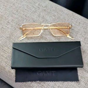 GAMT Luxurious Narrow Rectangular Metal Rim High Temple Sunglasses in Gold Champagne - 52mm