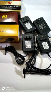 Black AC adapter with yellow tip cable(2pins). Output 5V-3.0A/ 12V-2A/ 9V-2A/ 6V-3A. Input 100-240V-50/60Hz 0.3A.