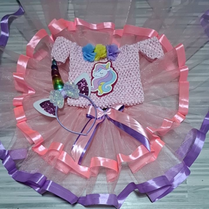 Unicorn dress with tutu skirt and headband for children. Pink crochet top with unicorn applique layered tulle skirt with pink and purple ribbons and matching unicorn headband with horn and ears.