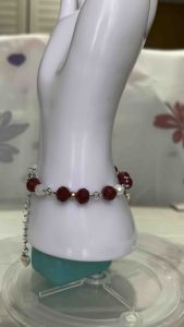 Red Beaded Bracelet with Silver Chain on Mannequin Display