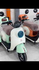 Electric motorcycle three wheels red and blue Mio type sleek design headlights handlebars mirrors.