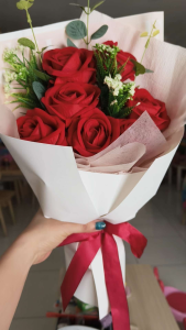 Artificial Bouquet Rose with greenery and white accents wrapped in white paper with red ribbon