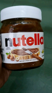 Nutella hazelnut spread with cocoa jar with white lid.