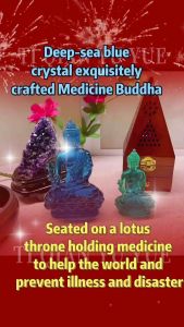 Blue and green translucent Buddha statues on a white surface with purple crystals and wooden incense holder in background.