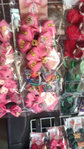 RANDOM Hair bows with floral and cartoon designs on display SOLD PER PAIR AND BULK