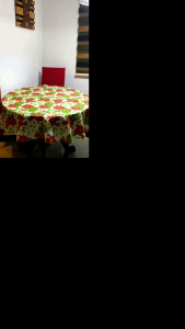 Christmas Tablecloth Round 4/6 Seater Tablecloths with red and green festive design suitable for holiday dining.