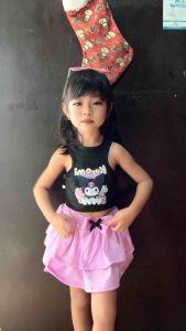 Black Kuromi tank top with pink ruffled skirt and bow.