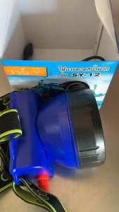 ไฟฉายคาดหัว ตราสามยิ้ม รุ่น SY-12 สำหรับแสงสว่างกว้างทนทาน กันน้ำได้