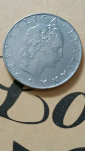 1970 Italy 50 Lire coin is a large stainless steel coin from the Italian Republic a standard circulation coin minted between 1954 and 1989. It has a diameter of 24.8 mm weighs 6.25 grams and features an image of the god Vulcan on the reverse and a fem