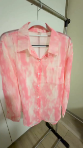 Pink and white tie-dye long sleeve button-up shirt with collar and chest pocket.