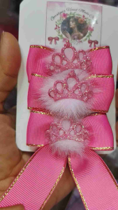 Pink tiara hair bows with gold trim and decorative beads.