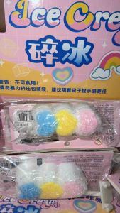 Three colorful marshmallow candies with blue yellow and pink toppings on a white base SQUISHY