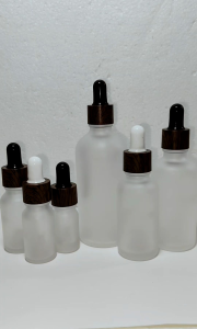 Frosted White Glass Bottles with Dark Wood Print Droppers for Serums and Oils