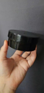 Black Jar Cosmetic Container Mockup - Glossy Finish - Stackable Design - Compact Size - Suitable for Skincare Products - Displayed on Stone Surface with Green Leaves