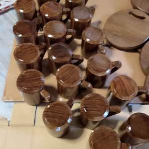 Brown wooden mugs with lids smooth finish handles multiple units kitchen setting