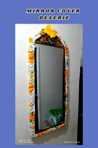 Mirror cover deserie design geena fabric. Blue floral patterned fabric frame. Blue bow accent. Wall-mounted mirror.