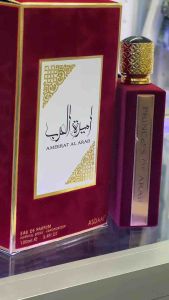 Ameerat Al Arab Eau de Parfum by Asdaaf. Rectangular deep red bottle with gold accents. Elegant packaging with Arabic script. 100ml.