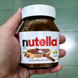 Nutella hazelnut chocolate spread 200gm jar with white lid and label featuring hazelnuts and bread slice.