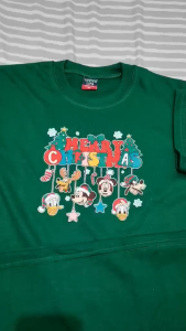 Luminous blue T-shirt with "Merry Christmas" text and Disney characters wearing Santa hats.