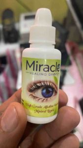 Miracle Healing Drops High Grade Alkaline Ionized Mineral Liquid. Two bottles with droppers. Blue eye image on label. Green background. Buy 1 Take 1 offer.
