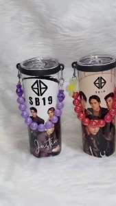Purple and red beaded tumbler straps with flower and heart charms black and purple loops metal clasps.