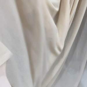 Cream-colored lightweight fabric with subtle sheen and soft texture. Suitable for clothing or home decor.