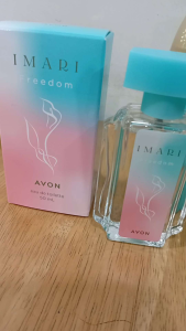 Avon Imari Freedom skincare set with four products: pink box blue spray bottle blue tube and blue roll-on.