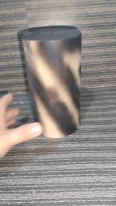 PVC ALKANSYA Bronze cylindrical vase with gradient finish 24.5 cm height textured surface decorative use placed on carpeted floor.