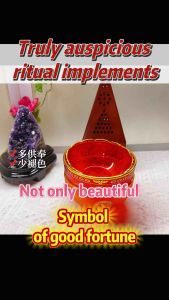 Red and orange glass bowls with gold designs incense burner amethyst crystal and decorative flowers.