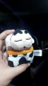Shin Chan Charm Plush keychain featuring cartoon character with closed eyes and cow print blanket