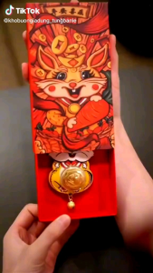 MÓC KHOÁ THẦN THỎ ÔM VÀNG 999 XOAY TRÒN