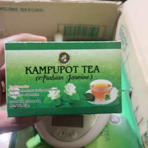 Kampupot Tea (Arabian Jasmine) green box with jasmine flowers and tea bags on wooden tray