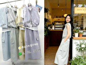 Light blue sleeveless vest layered over white shirt paired with matching high-waisted skirt. White cap and handbag accessorize the outfit. Outdoors in garden setting.