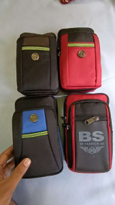Black and blue multi-compartment pouch with zippers and logo.