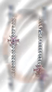 Elegant dangling earrings with sparkling crystals and purple accents. Suitable for formal occasions.