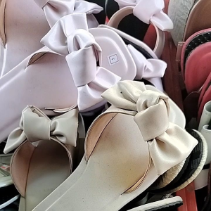 Brown slip-on sandals with large bows on top. Flat sole open back square toe design. Suitable for casual wear.