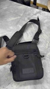TRION MINI 2 Quick Draw black crossbody bag with multiple zippered compartments adjustable strap and D-ring detail.