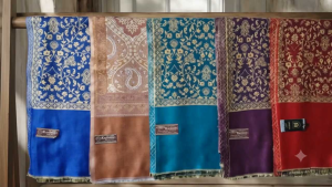 Purple embroidered shawl with gold floral patterns and border.