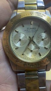Đồng hồ nam thương hiệu Elnard phối màu demi (vàng-bạc) size 41mmvới thiết kế 6 kim và vành bezel tachymeter lấy cảm hứng từ dòng Rolex Daytona cổ điển. thép không gỉ dài cho cổ tay 185cm đáy xoáy chống nước 10BAR