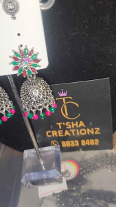 Gold Jhumka Earrings with White Stones and Dangling Details