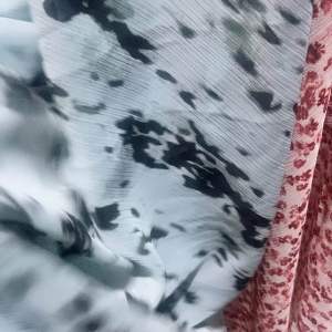 Powder blue fabric with black abstract pattern and off white floral chiffon fabric sold per yard