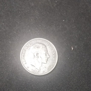 Silver coin featuring profile of Alfonso XII dated 1885 with inscription &quotPOR LA G. DE DIOS&quot on black background. AU details preloved.