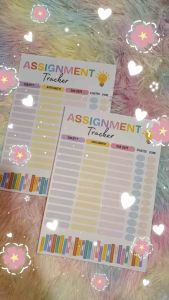 Assignment Tracker with columns for Subject Assignment Due Date Started and Done. Features colorful book illustrations and a light bulb icon. Designed for organizing schoolwork.