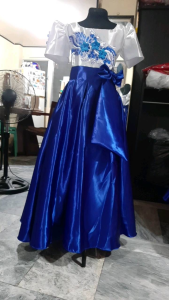 Filipiniana gown for kids in mestiza cuff attached sleeve. Detailed with lace embroidery application and with big side ribbon. Best fit for girls ages 6 to 8 years old standing 4 ft to to 4.10 ft tall.This item comes with a special freebie.