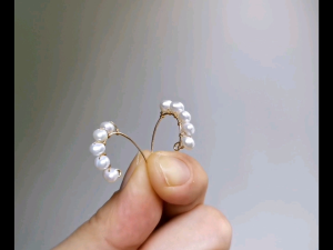 DaVee 14K gold filled freshwater pearl earrings with curved design and multiple pearls.